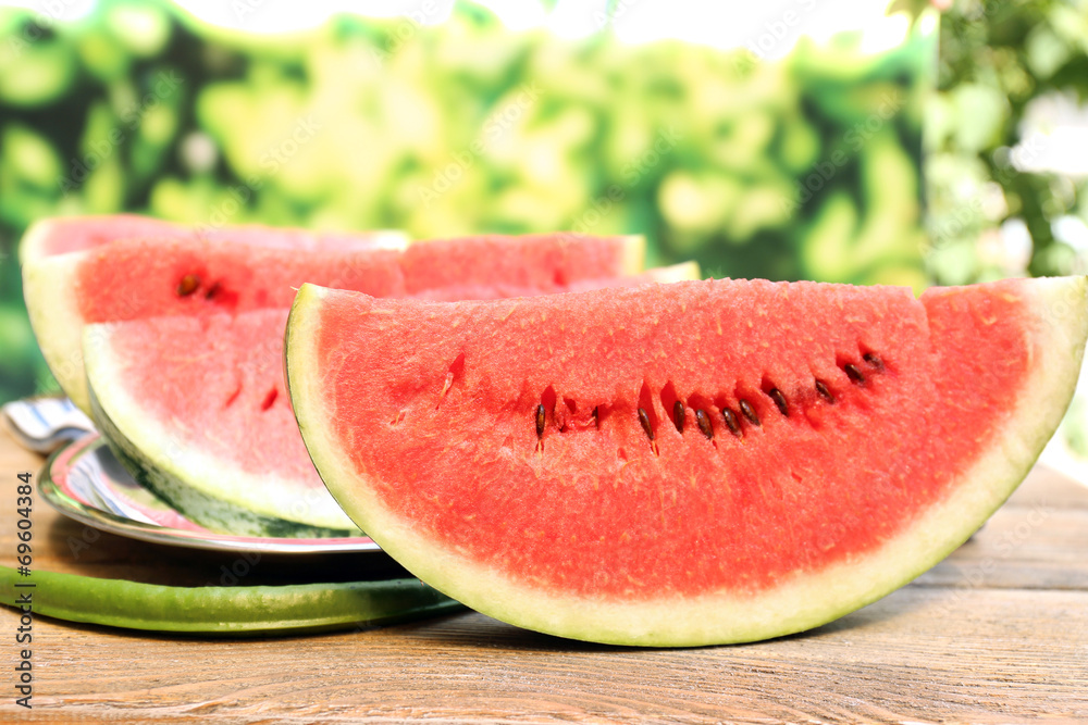 Fresh slice of watermelon on table outdoors, close up Fresh slice of watermelon on table outdoors, close up