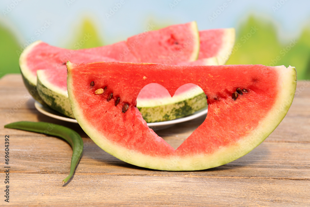 Fresh slice of watermelon on table outdoors, close up Fresh slice of watermelon on table outdoors, close up