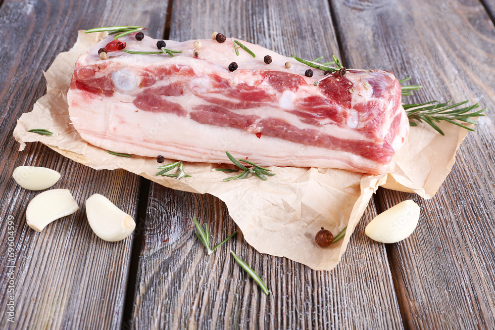 raw bacon with spices on wooden table raw bacon with spices on wooden table