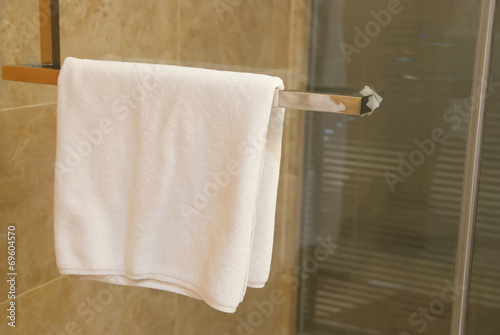 towel hanging on door of a shower room