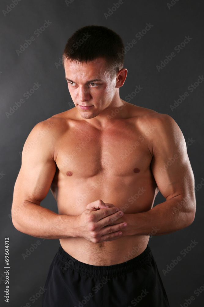Handsome muscle young man on dark background Handsome muscle young man on dark background