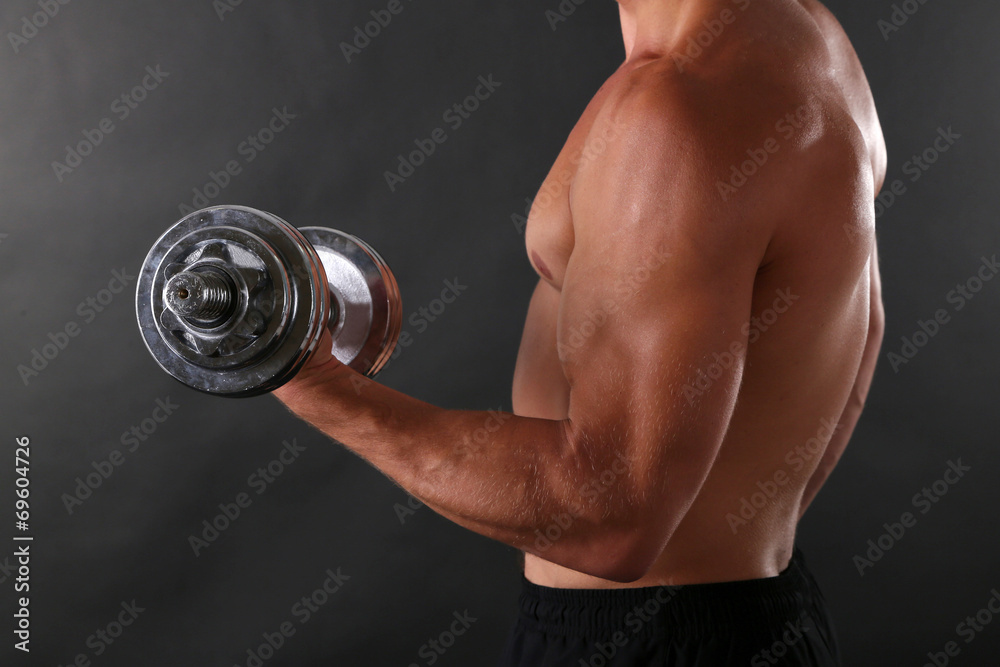 Handsome young muscular sportsman execute exercise with Handsome young muscular sportsman execute exercise with