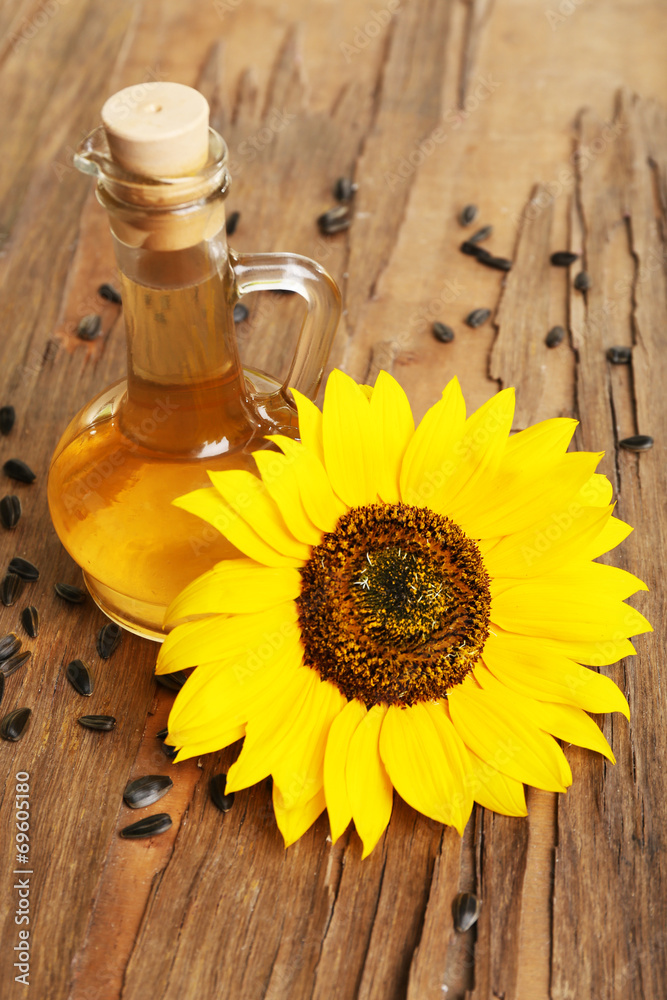 Sunflower with seeds and oil on wooden background Sunflower with seeds and oil on wooden background