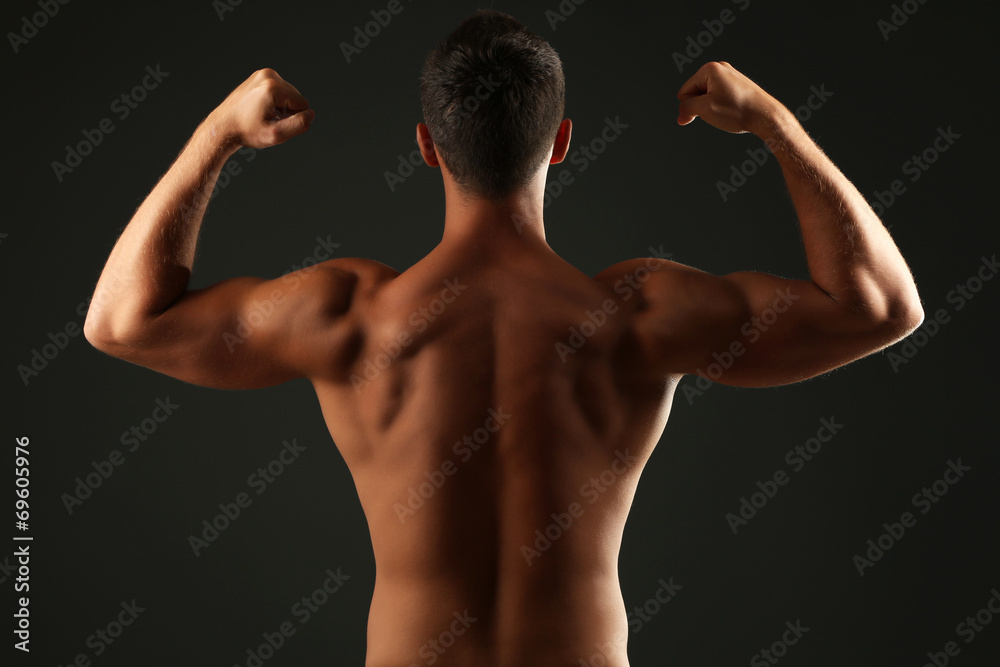 Fototapeta premium Handsome muscle young man on dark background