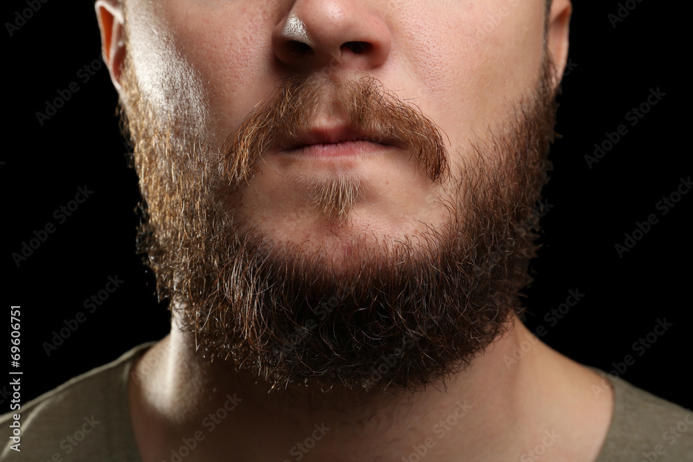 Closeup of long beard and mustache man on dark background Closeup of long beard and mustache man on dark background