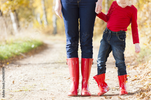 Schilderij op canvas detail of mother and daughter wearing rubber boots