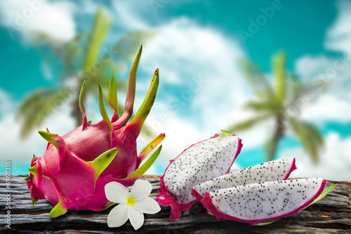 Dragon fruit and flower with  coconut and sky blur on background