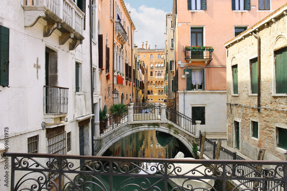 Picturesque Italian houses on a narrow canal in Venice, Italy