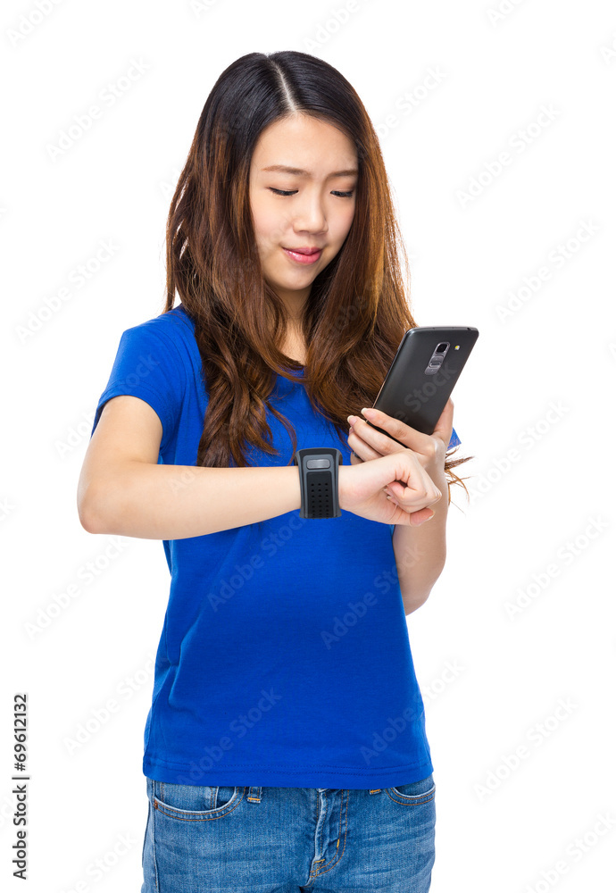 Woman use smartphone to connect with wearable watch Woman use smartphone to connect with wearable watch