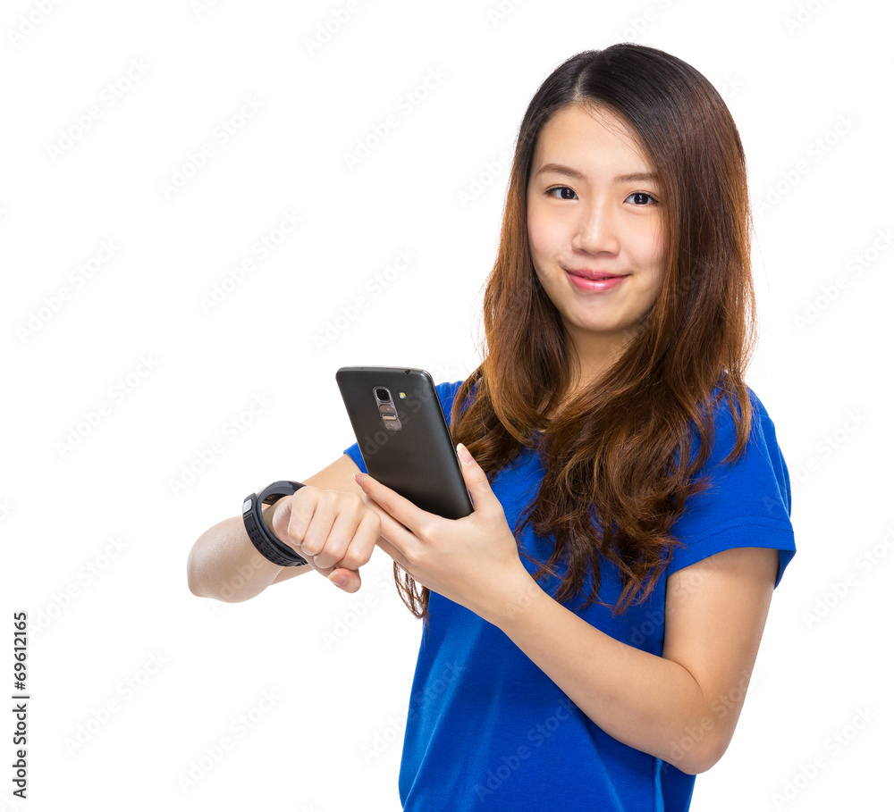 Woman with wearable device sonnect with cellphone Woman with wearable device sonnect with cellphone