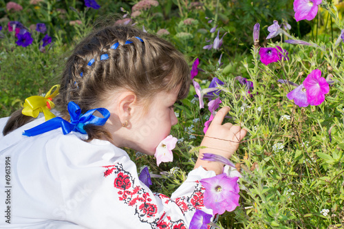 little girl smelling flowers