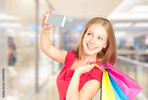 Selfie, a successful shopping happy woman with shopping bags