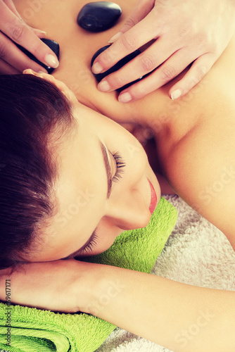 Beautiful woman lying on spa salon.
