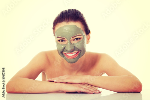 Beautifu toplessl woman with facial mask. photo