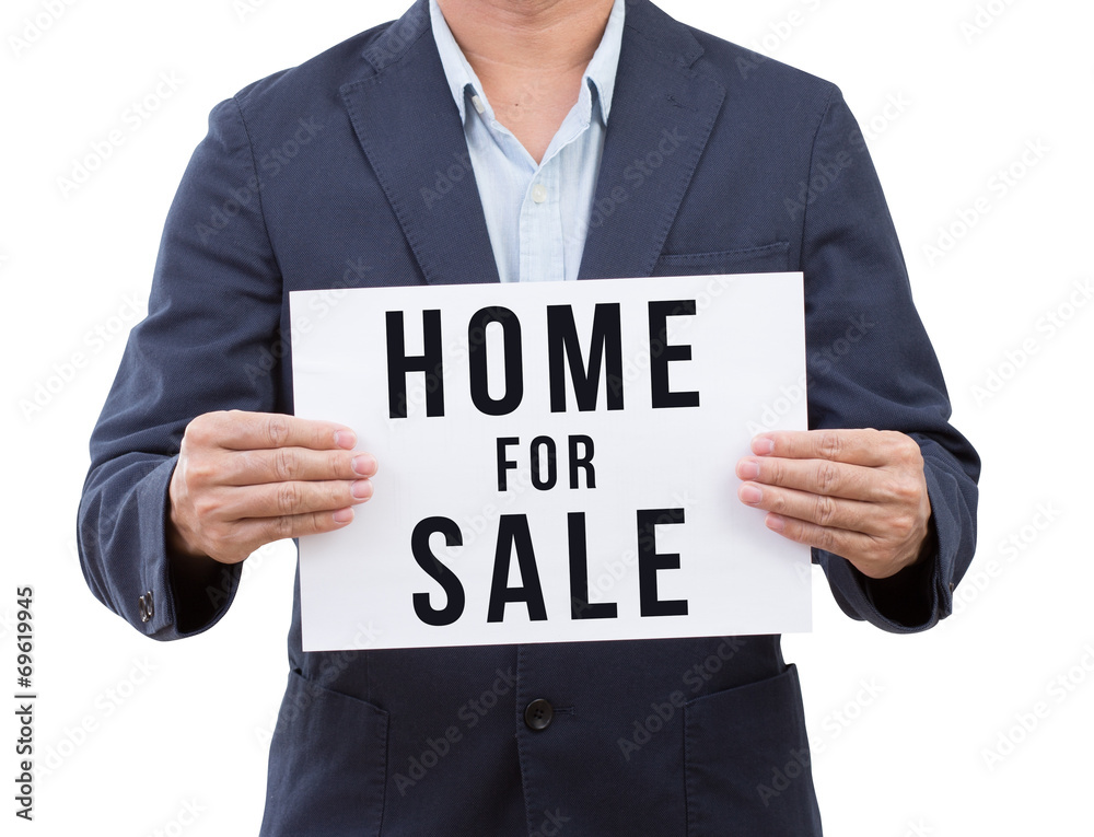 Business man hand holding home for sale banner isolated on white Business man hand holding home for sale banner isolated on white