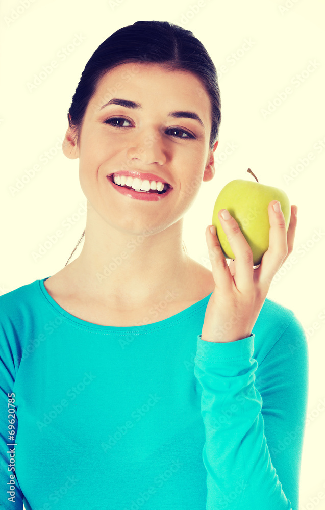 Young casual woman holding an apple. Young casual woman holding an apple.