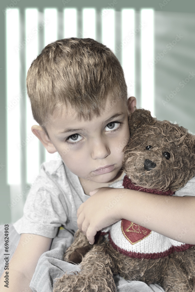 Small lonely boy with a teddy bear Small lonely boy with a teddy bear