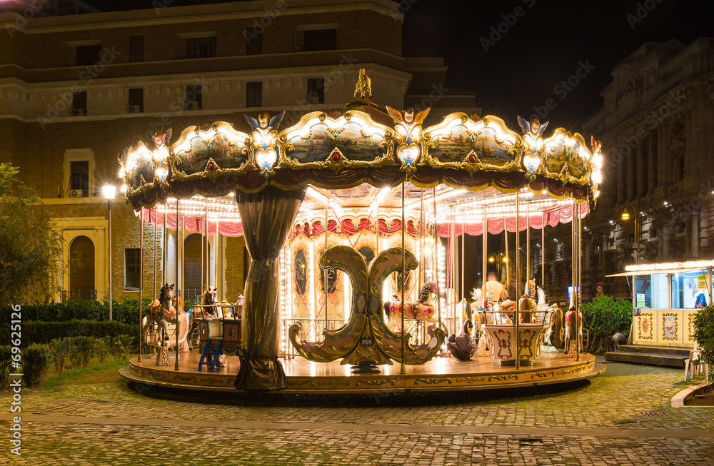 Fototapeta premium Merry-Go-Round illuminated at night in Rome. Italy