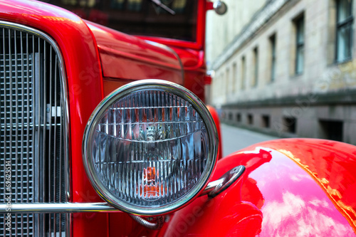 Headlamp of vintage red car photo