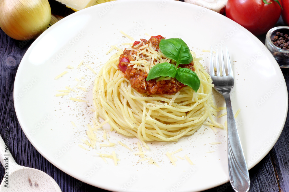 Spaghetti on white plate with fork