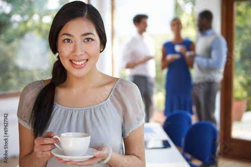 Casually Dressed Businesswoman At Meeting In Boardroom