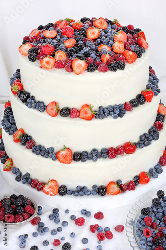 Wedding cake with fruits on white background