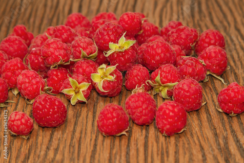 Fresh raspberries on wooden background