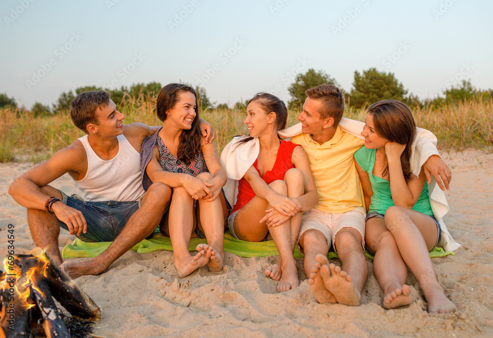 smiling friends in sunglasses on summer beach smiling friends in sunglasses on summer beach