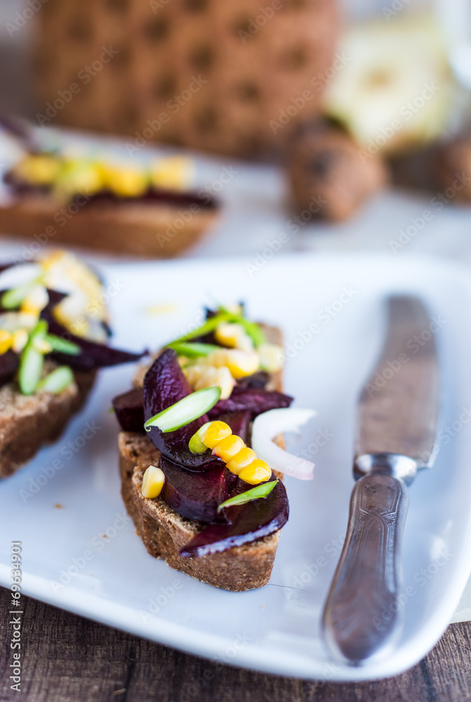 vegetarian sandwich with vegetables on white plate,knife vegetarian sandwich with vegetables on white plate,knife