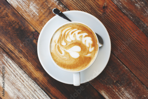 Coffee cup on wooden table, artistic photo