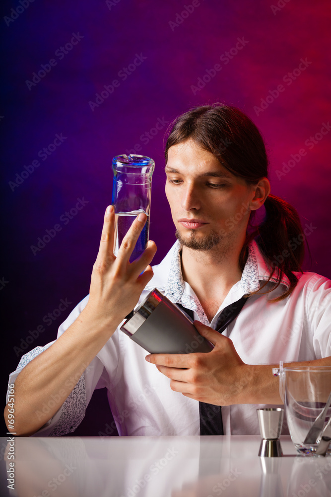 Young man bartender preparing alcohol cocktail drink Young man bartender preparing alcohol cocktail drink