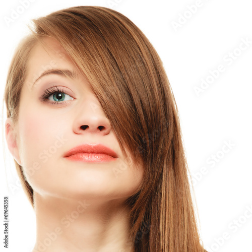 Hairstyle. Portrait of girl with long bang covering eye