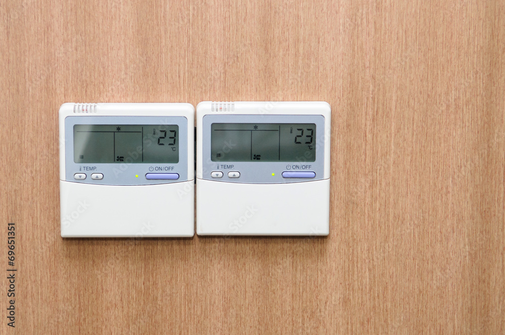 Digital thermostat on wood wall Digital thermostat on wood wall