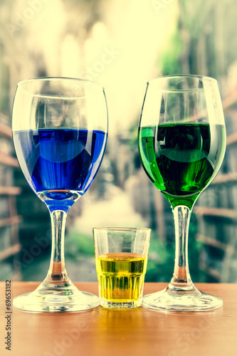 Glasses with green and blue cocktail yellow shot