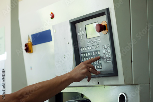 Man presses button on electronic control panel