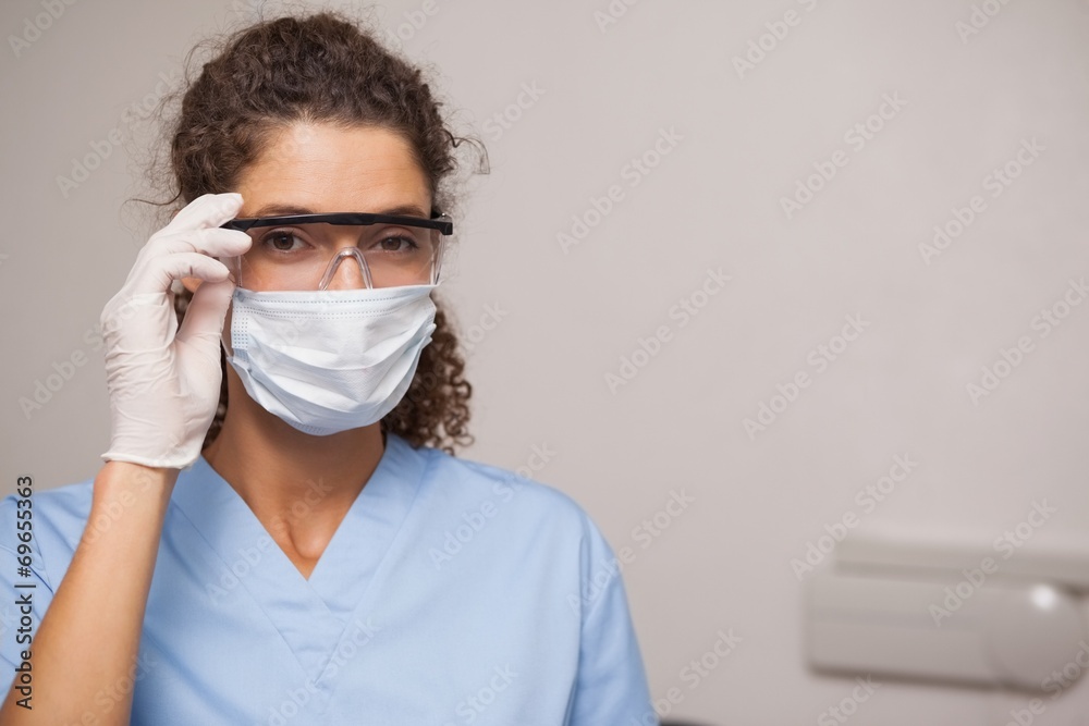 Dentist in surgical mask and protective glasses Dentist in surgical mask and protective glasses