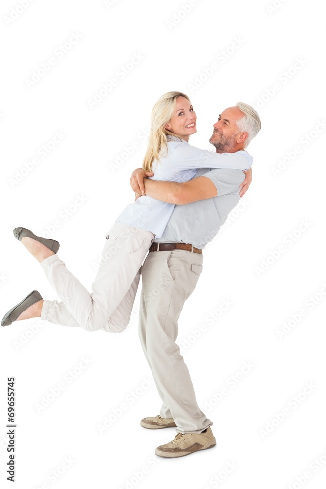 Man picking up his partner while hugging here Man picking up his partner while hugging here
