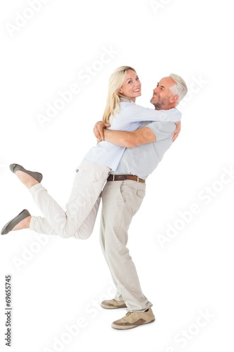 Man picking up his partner while hugging here