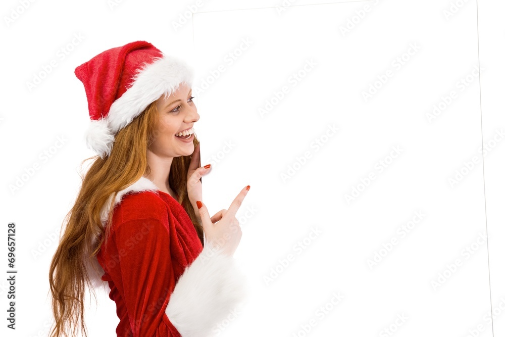Festive redhead smiling at camera holding poster Festive redhead smiling at camera holding poster