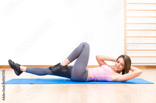 young healthy woman in abs exercises