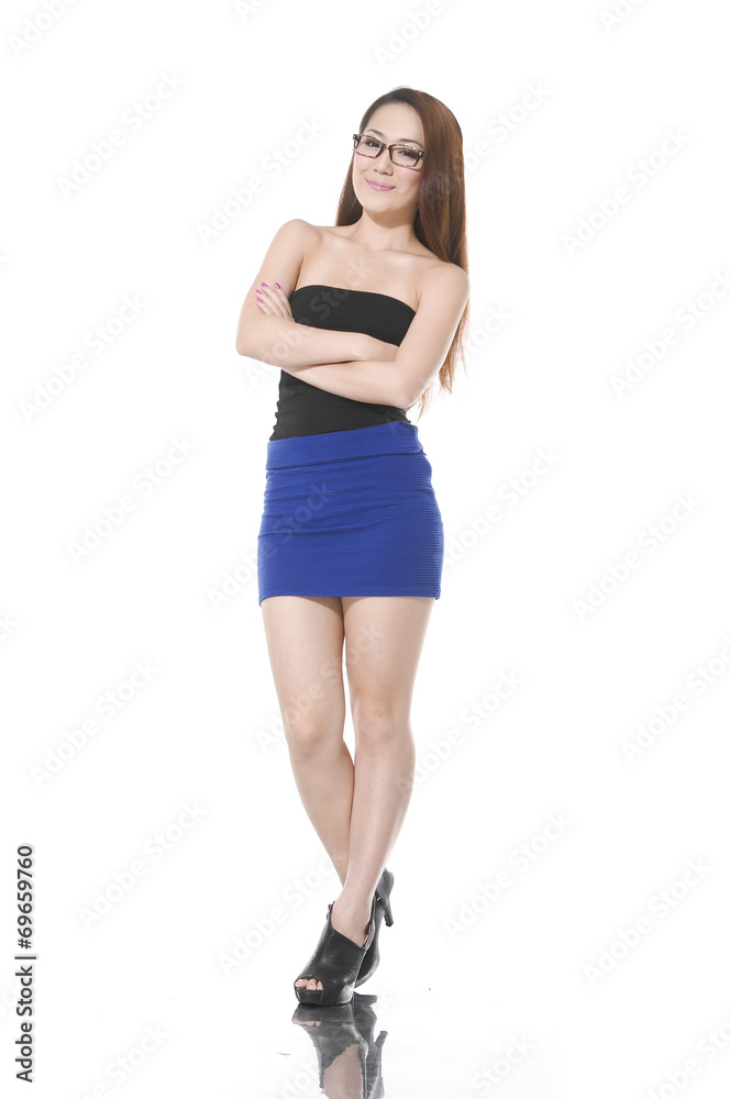 young woman standing with her hands folded young woman standing with her hands folded