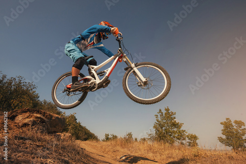 Mountain Bike cyclist jumping. Downhill biking.