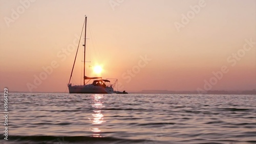 Boat silhouettes at sunset in Ria Formosa wetlands