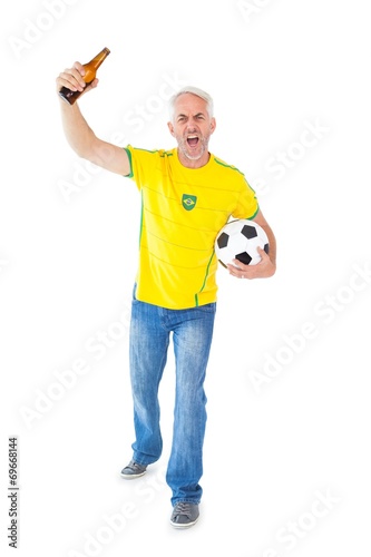 Cheering brazilian football fan in yellow