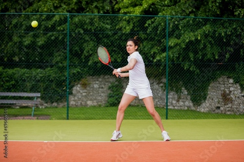 Pretty tennis player about to hit ball © WavebreakMediaMicro