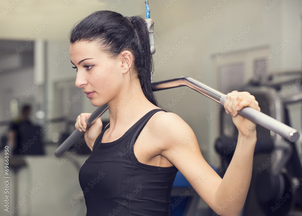 young girl goes in for sports in the gym bodybuilding