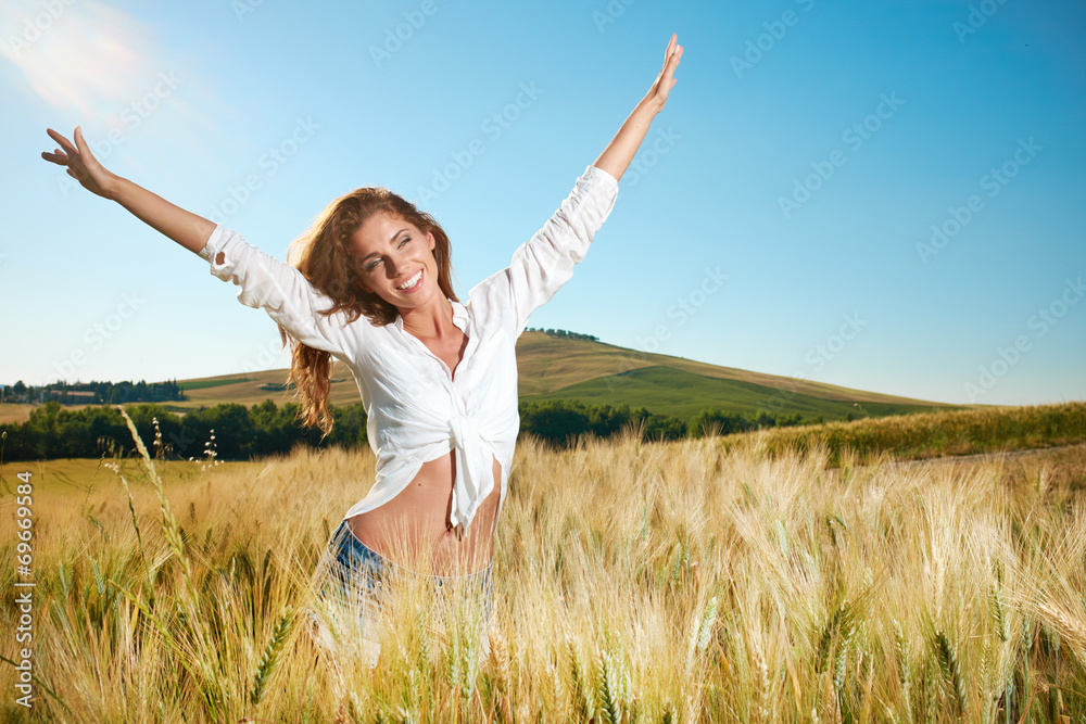 Beautiful brunette lady in wheat field at sunset Beautiful brunette lady in wheat field at sunset
