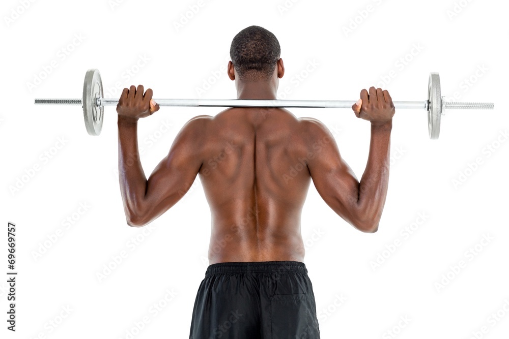 Rear view of a fit shirtless man lifting barbell Rear view of a fit shirtless man lifting barbell
