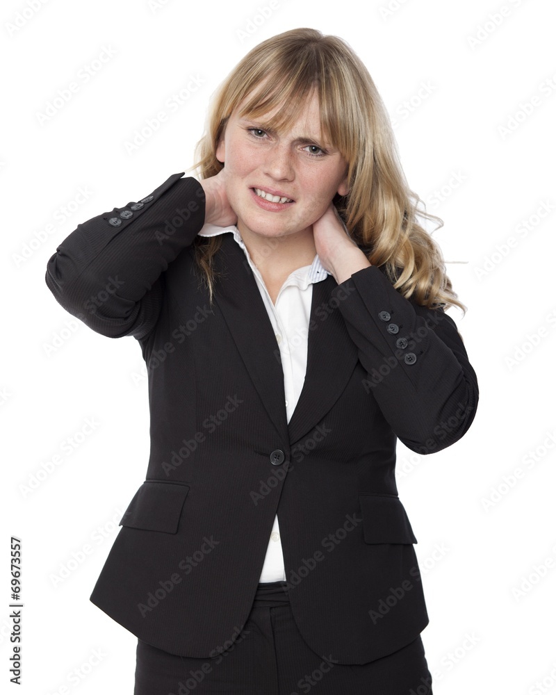 Young businesswoman rubbing her sore neck Young businesswoman rubbing her sore neck