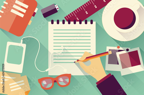 Writing into notebook background with coffee, photos, glasses